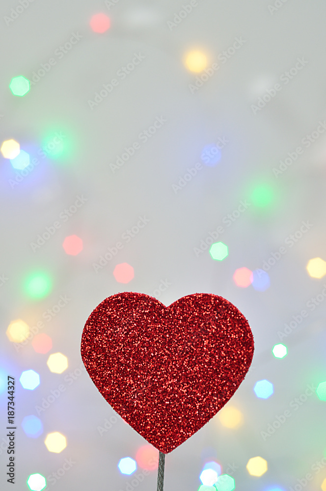 A red heart isolated against an out of focus light background