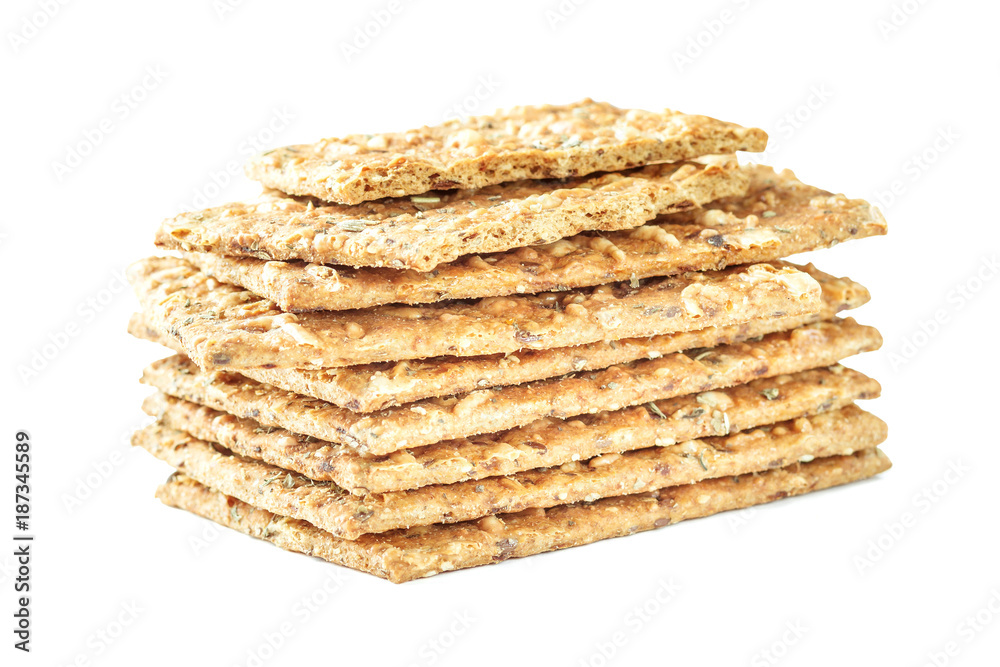 Stack of crispy wheat flatbread crackers with seeds isolated on a white background Stack of crispy wheat flatbread crackers with seeds isolated on a white background