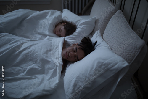 Young couple sleeping in bed together