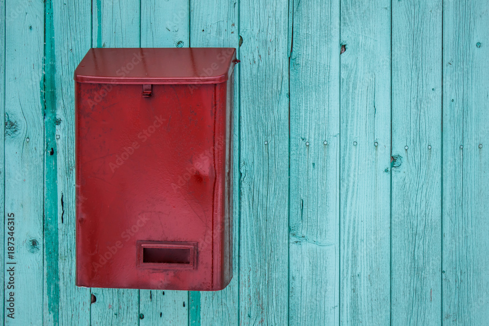 Red mail box on blue wooden wall Red mail box on blue wooden wall