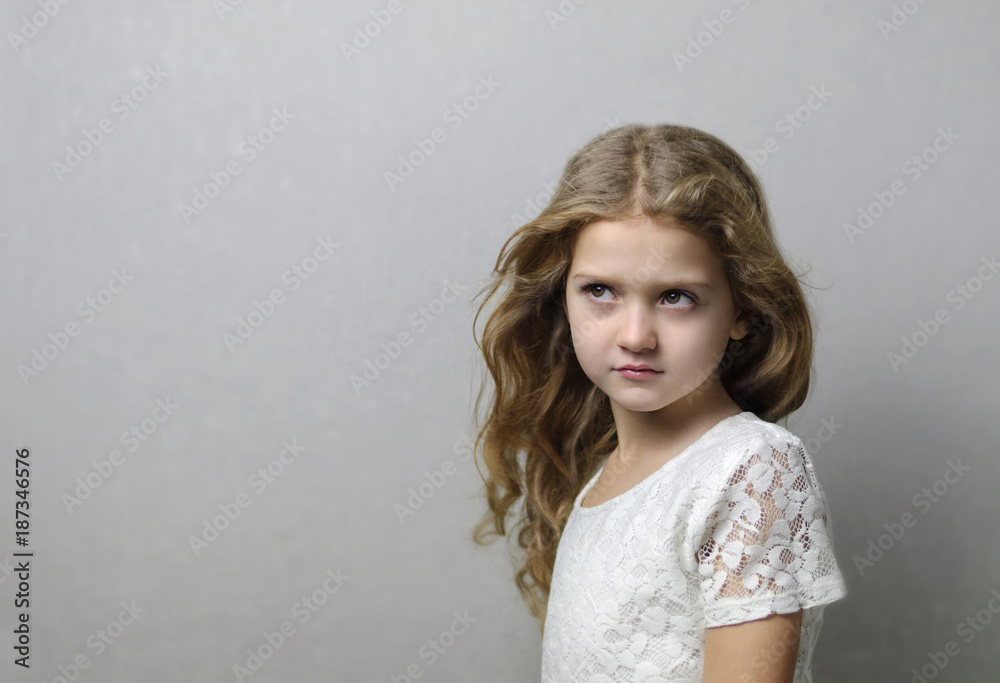 beautiful little girl with long blond hair on grey background beautiful little girl with long blond hair on grey background