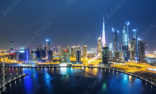 Dubai skyline and water canal with promenade after the sunset  Dubai United Arab Emirates