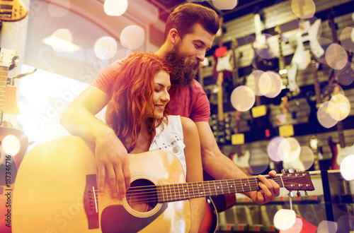 couple of musicians with guitar at music store
