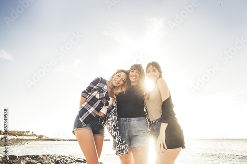 Three young beauty women at the beach join the summer