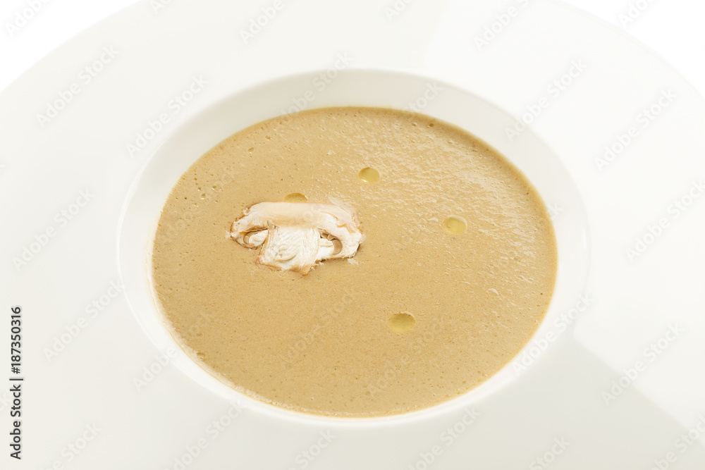 Mushroom cream soup and champignon on white plate Mushroom cream soup and champignon on white plate