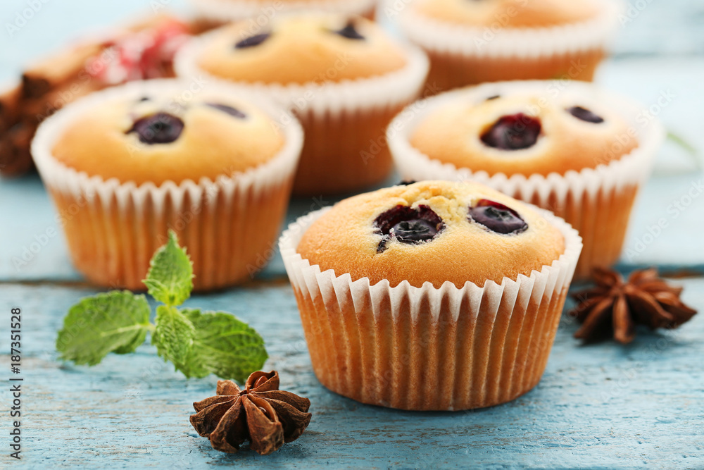 Sweet blueberry muffins on grey wooden table