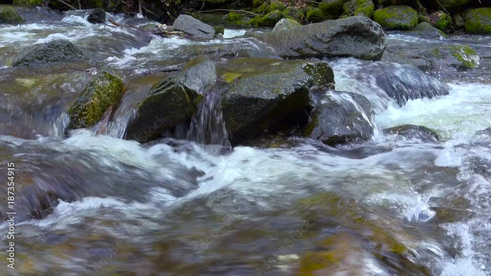 Mountain river, water flowing over rocks and boulders Mountain river, water flowing over rocks and boulders