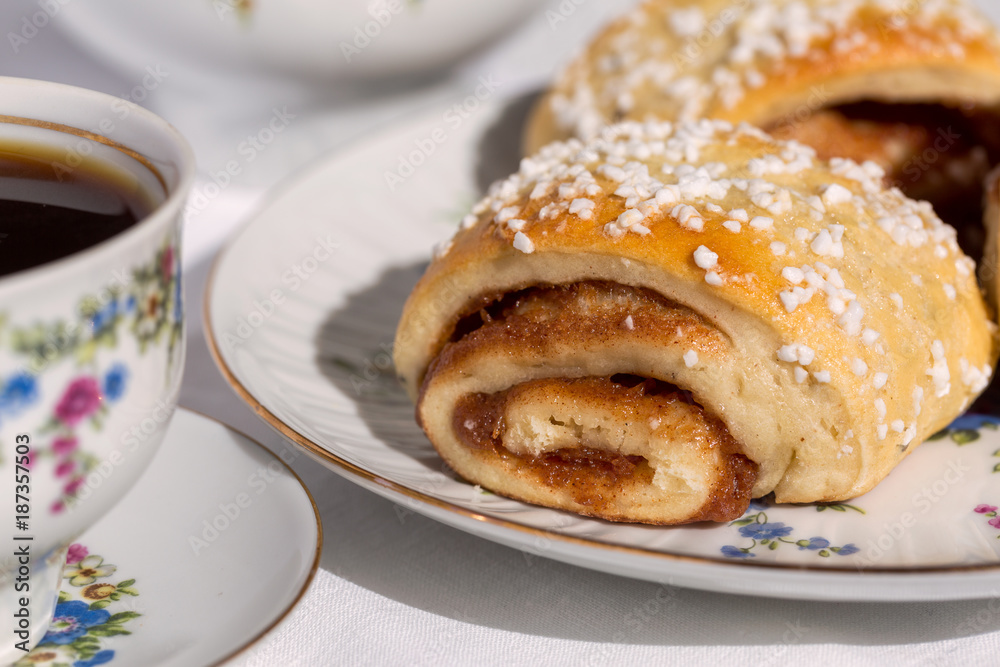Cinnamon rolls and cup of coffee, close-up Cinnamon rolls and cup of coffee, close-up
