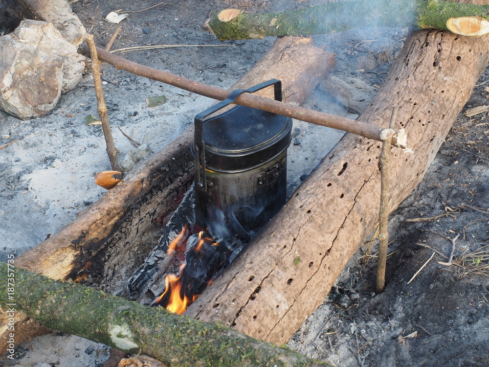 Rice cooking with army pot on fire while camping Rice cooking with army pot on fire while camping