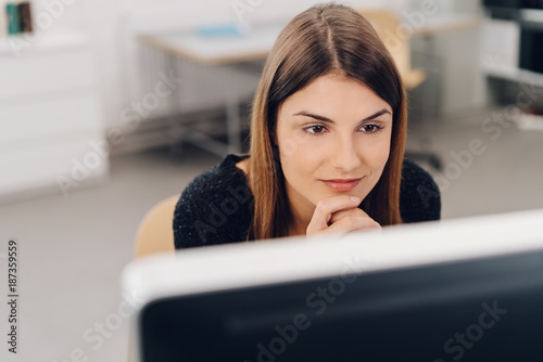 Natural young businesswoman sitting working