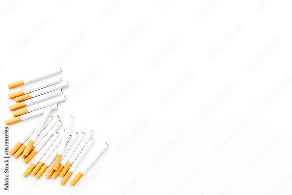Tobacco. Row of cigarettes on white background top view copyspace Tobacco. Row of cigarettes on white background top view copyspace