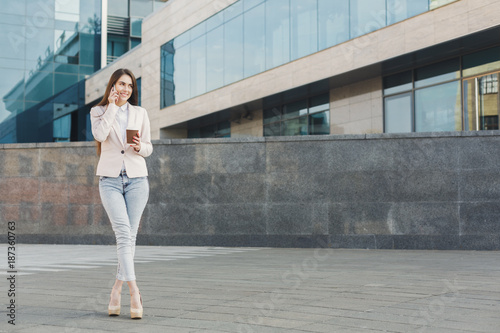 Confident young businesswoman talking on cell