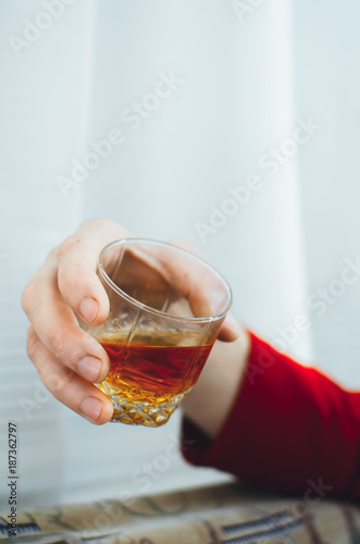 Hands with glasses of whiskey, clink