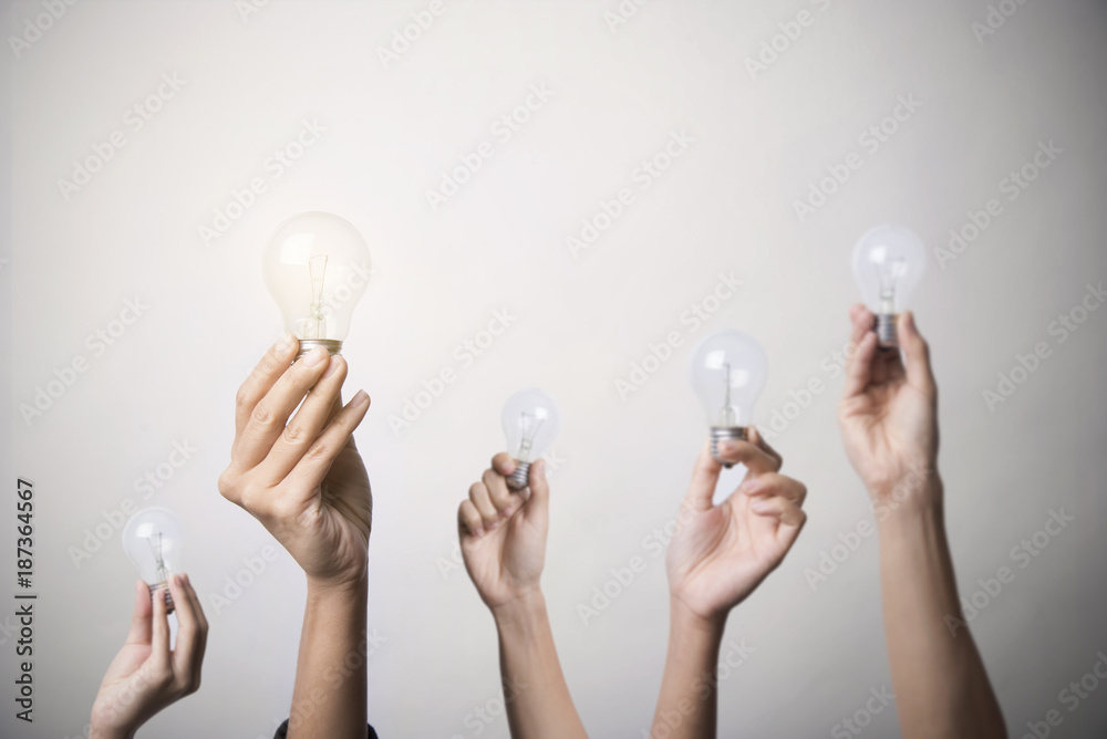 hand holding light bulb, concept teamwork ideas with innovation and creativity. - obrazy, fototapety, plakaty 
