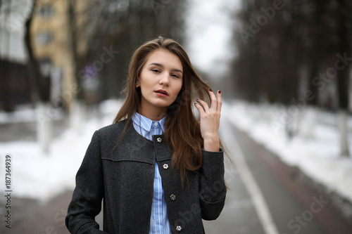 Young adult girl in coat on the street