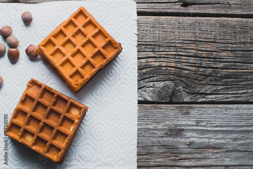 Waffle on a wooden background on a white napkin