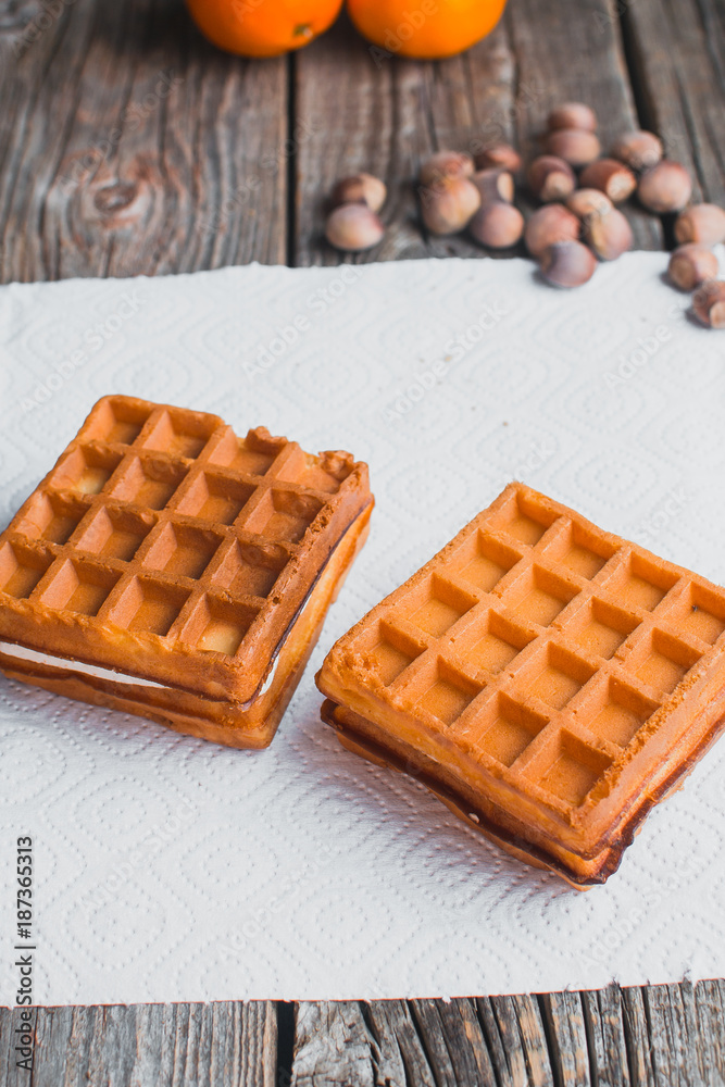 Waffle on a wooden background on a white napkin Waffle on a wooden background on a white napkin