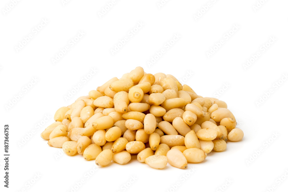 Heap of pine nuts on a white, closeup. Heap of pine nuts on a white, closeup.