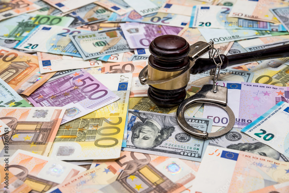 crime concept - handcuffs, gavel dollar and euro bills