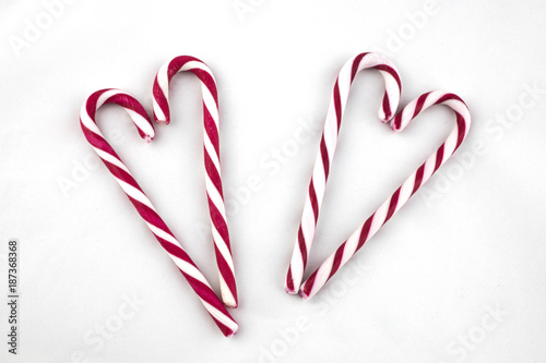 Candy Canes arranged in a heart shape. Isolated on a white background.