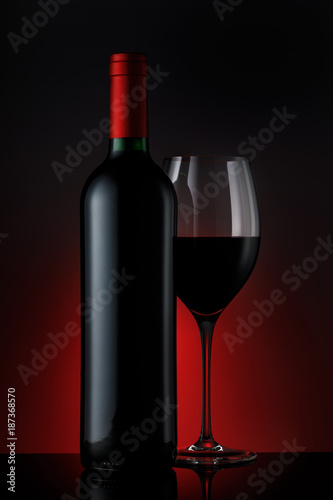  Bottle of red wine with a glass on a black background, vertical close-up image