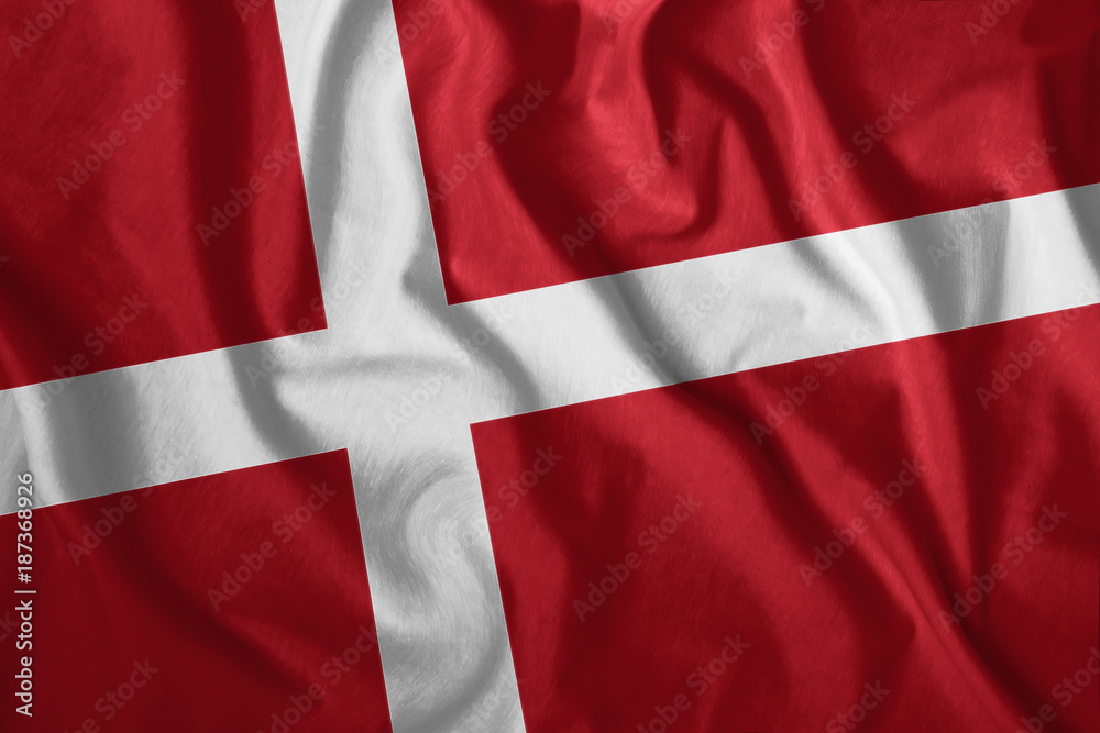 The Danish flag flutters in the wind. Colorful, national flag of Denmark. Patriotism, a patriotic symbol. The Danish flag flutters in the wind. Colorful, national flag of Denmark. Patriotism, a patriotic symbol.