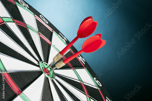 Dart board targeting the center on a  blue background