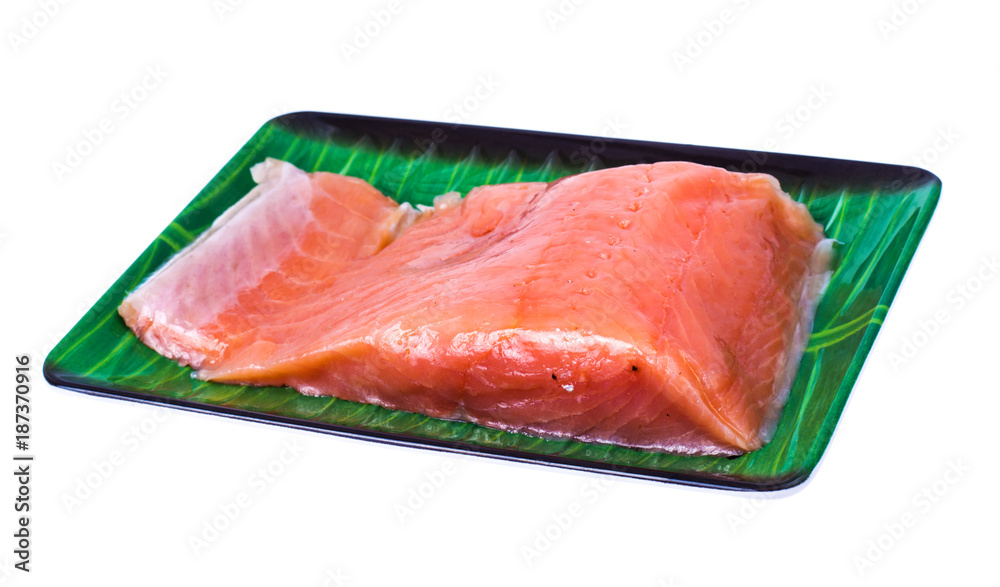Piece of smoked salted salmon on green plate Piece of smoked salted salmon on green plate