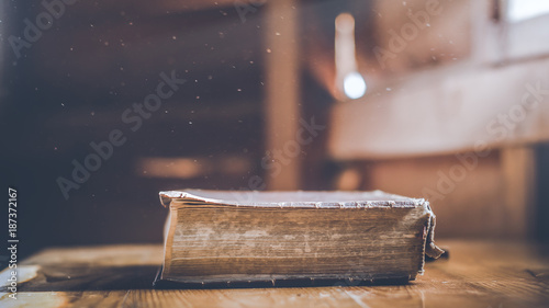 Old holy Bible on wooden table photo