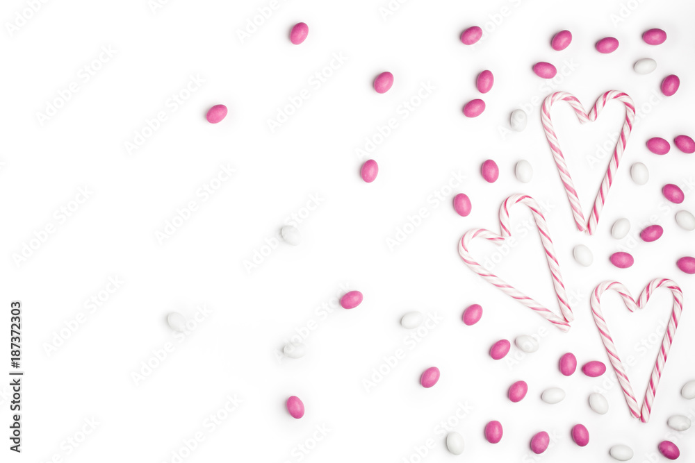 Pink and White candies and lollipops Top view White Background Valentine's Day