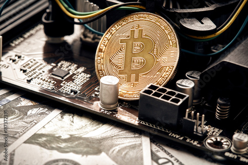 The coin of bitcoin lies on video card with dollars. Exchange bitcoin cash for a dollar photo