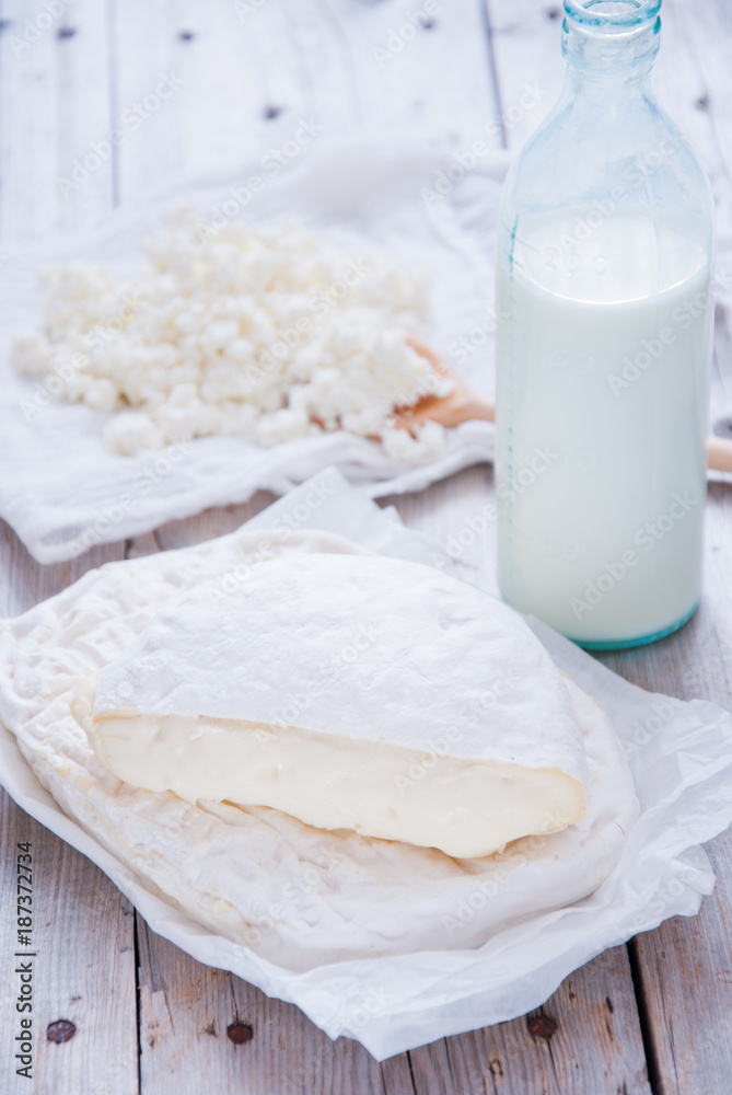 Homemade cheese Camembert and Brie on a gray wooden background Homemade cheese Camembert and Brie on a gray wooden background