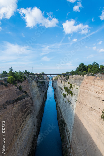 The Corinth Canal connects the Gulf of Corinth with the Saronic Gulf in the Aegean Sea. It cuts through the narrow Isthmus of Corinth and separates the Peloponnese from the Greek mainland