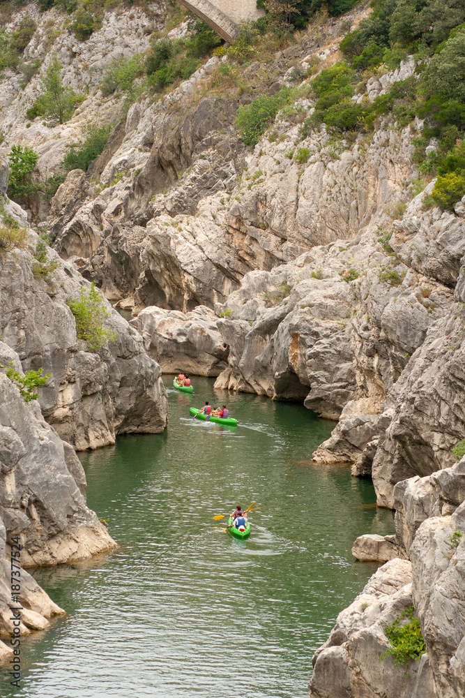 People kayaking on canyon river of Herault, in the south of France