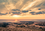 Split-toned HDR landscape of Cyprus countryside with dry terrain and Mediterranean sea.