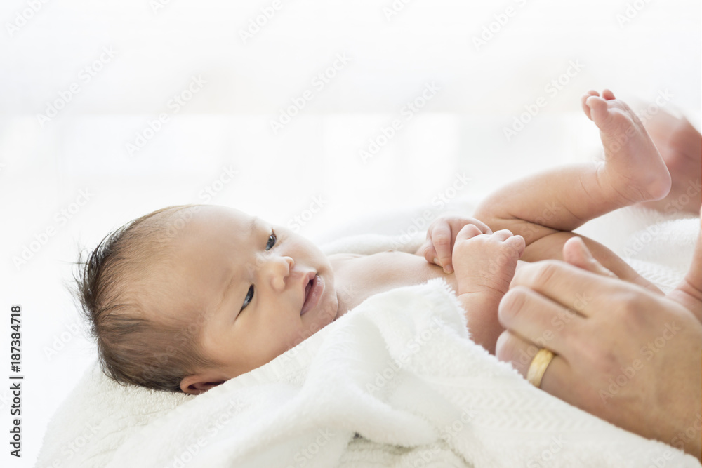 Drying a happy newborn baby with towel after bath Drying a happy newborn baby with towel after bath