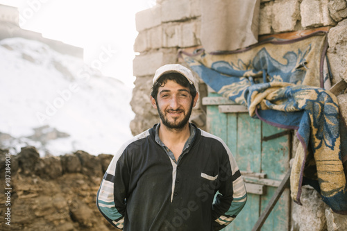 portrait of a smiling kurdish farmer in front of his barn photo