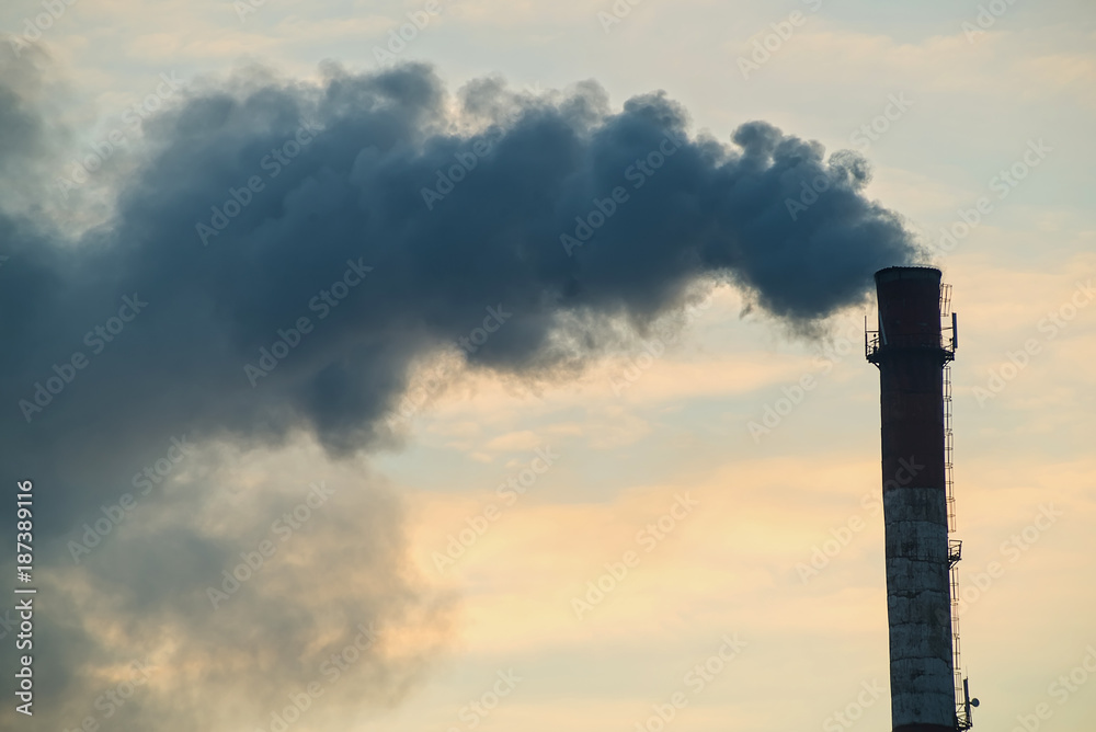 Pipe with smoke on a background of the sky close-up, with copy space. Pipe with smoke on a background of the sky close-up, with copy space.
