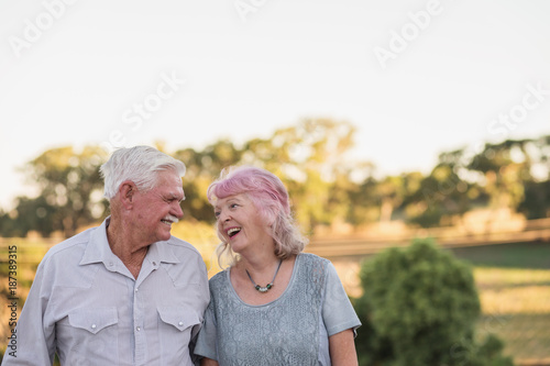 fun senior couple smiling to each other photo