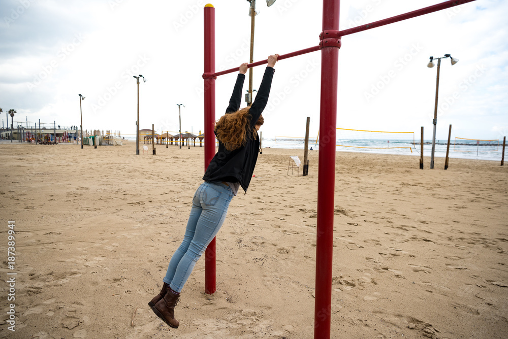 Girl Swinging on the Beach