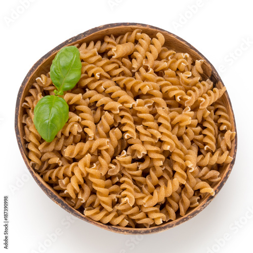 Uncooked wholemeal pasta isolated white background.