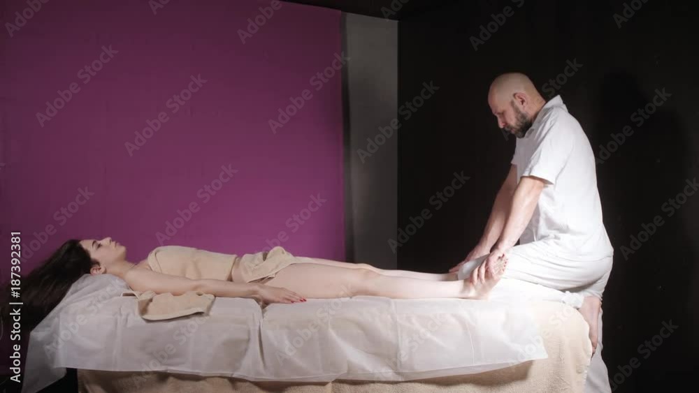 Wellness foot massage. Close up of osteopath doing manipulative massage. Man hands massaging female. Spa centre concept Wellness foot massage. Close up of osteopath doing manipulative massage. Man hands massaging female. Spa centre concept