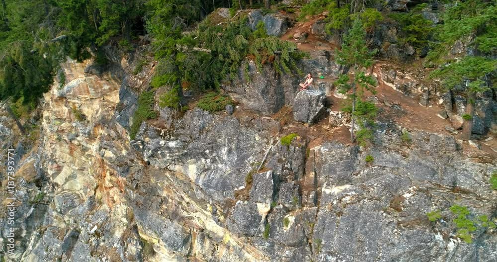 Woman performing yoga on top of a mountain Woman performing yoga on top of a mountain