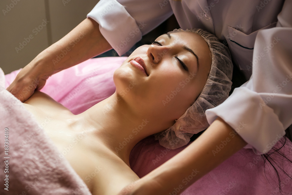 calm girl having spa facial massage in luxurious beauty salon