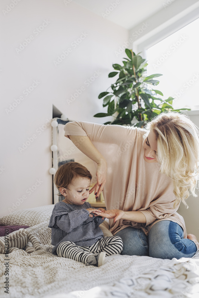 Mother Applying Cream on Baby's Face Mother Applying Cream on Baby's Face