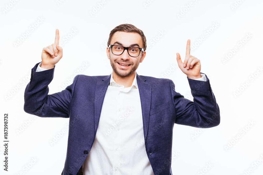 Portrait of a young business man having idea and pointing finger up isolated on the white background Portrait of a young business man having idea and pointing finger up isolated on the white background