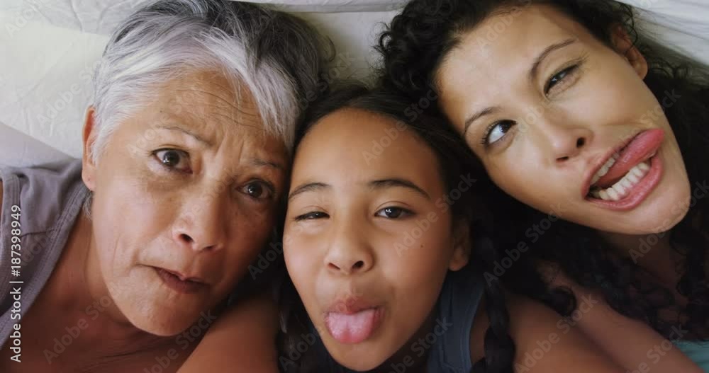 Happy family lying on bed in bed room Happy family lying on bed in bed room
