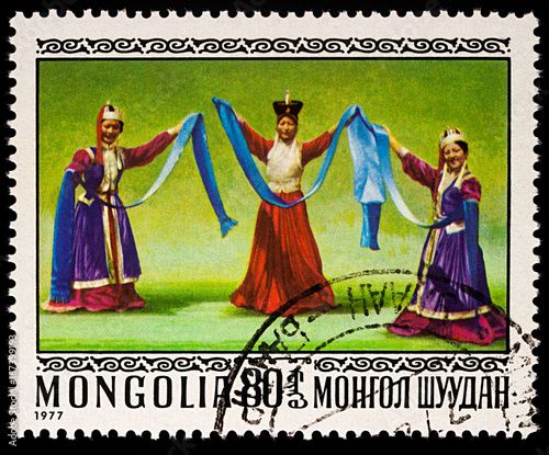 Three dancing women on postage stamp photo