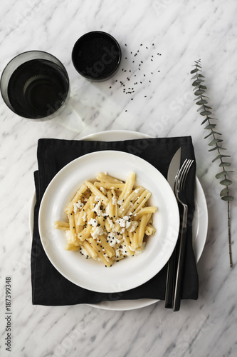 Pasta with ricotta cheese and black cumin photo