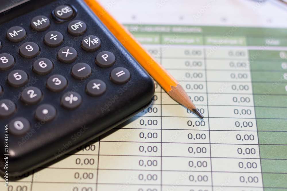 Finance concept - Calculator, pencil and graphs Finance concept - Calculator, pencil and graphs